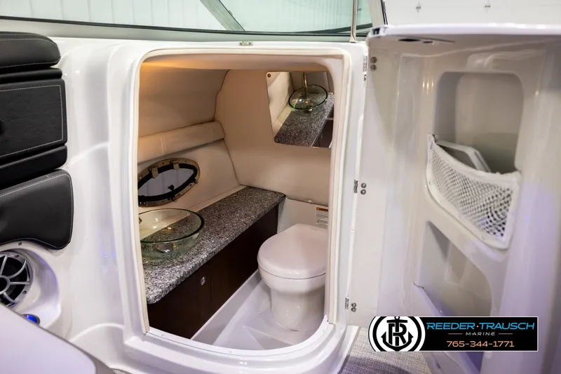 Slide: The Image of 2022 Crownline 265 SS boat interior bathroom with modern amenities and sleek design. - 28
