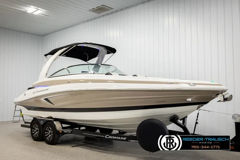 Slide: The Image of 2022 Crownline 265 SS boat on trailer in indoor showroom. - 3