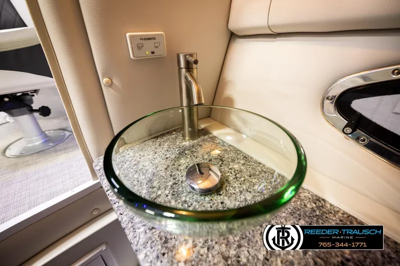 Slide: The Image of 2022 Crownline 265 SS boat interior with modern glass sink and granite countertop. - 30