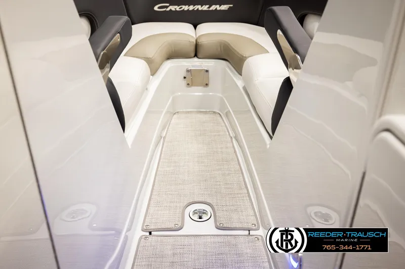 Slide: The Image of 2022 Crownline 265 SS boat interior with cushioned seating and carpeted flooring. - 34