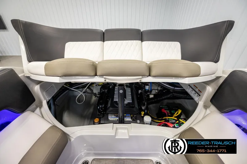 Slide: The Image of 2022 Crownline 265 SS boat engine compartment with seating, showcased by Reeder-Trausch Marine. - 37