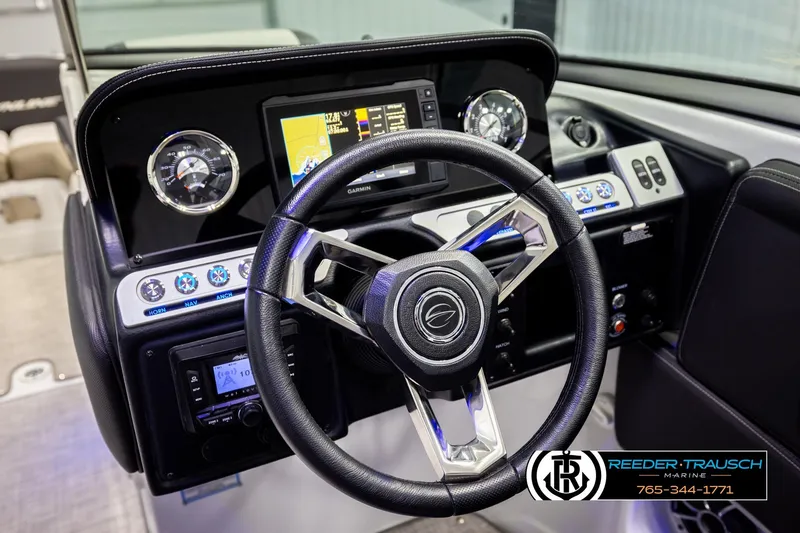 Slide: The Image of 2022 Crownline 265 SS boat dashboard with steering wheel and Garmin display. - 43