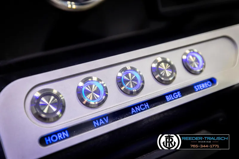 Slide: The Image of Control panel of 2022 Crownline 265 SS boat with illuminated buttons for various functions. - 46