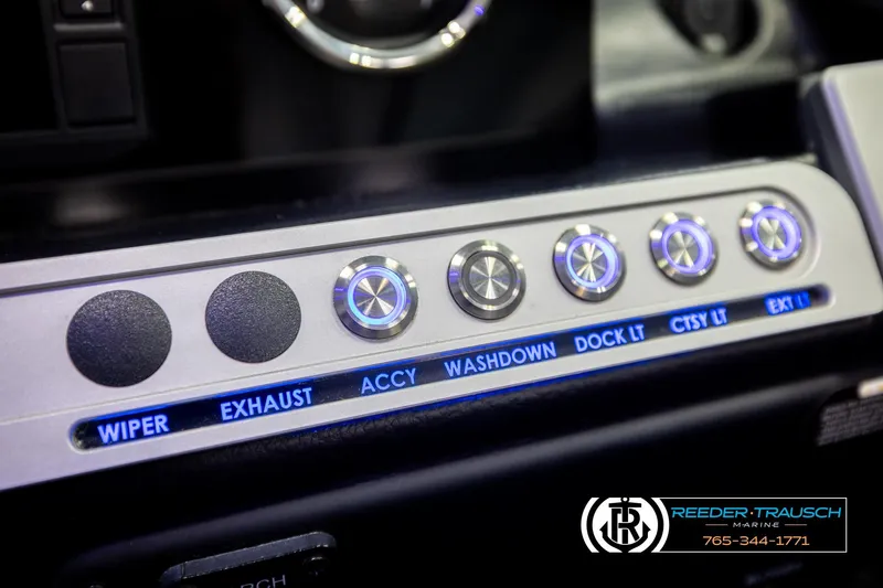 Slide: The Image of Control panel of 2022 Crownline 265 SS boat with labeled buttons and switches. - 52