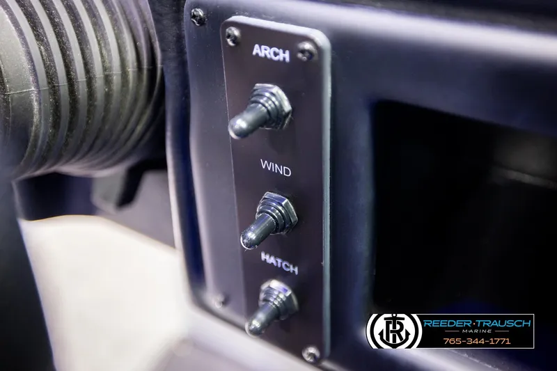 Slide: The Image of Control panel of 2022 Crownline 265 SS boat with labeled switches. - 53