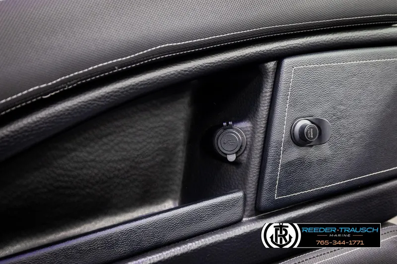 Slide: The Image of 2022 Crownline 265 SS dashboard with USB port and ignition switch, Reeder-Trausch Marine branding. - 56