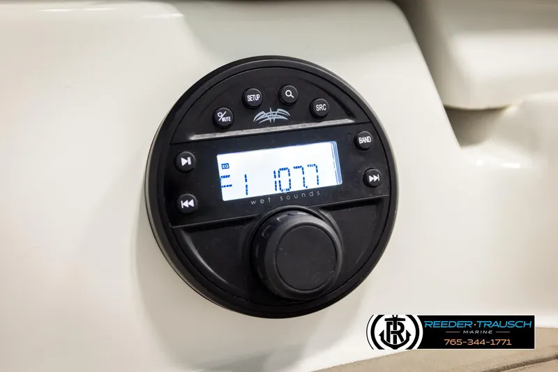 Slide: The Image of 2022 Crownline 265 SS audio control panel with digital display and buttons. - 68