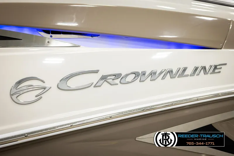Slide: The Image of 2022 Crownline 265 SS boat with sleek design and illuminated branding. - 76