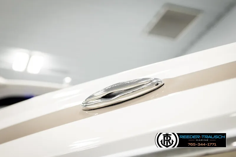 Slide: The Image of 2022 Crownline 265 SS boat detail with sleek design and chrome accent. - 77