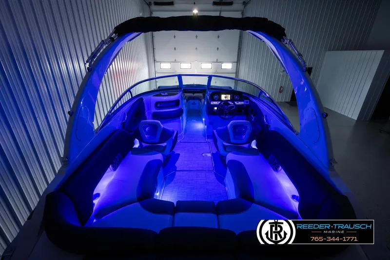 Slide: The Image of 2022 Crownline 265 SS boat interior with blue LED lighting in a garage. - 9