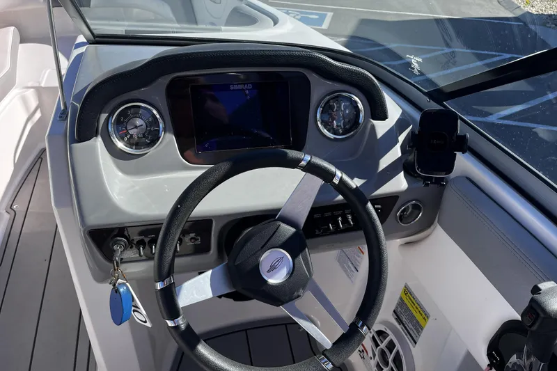 Slide: The Image of Cockpit view of 2021 Chaparral 21 SSi boat with steering wheel and dashboard controls. - 5