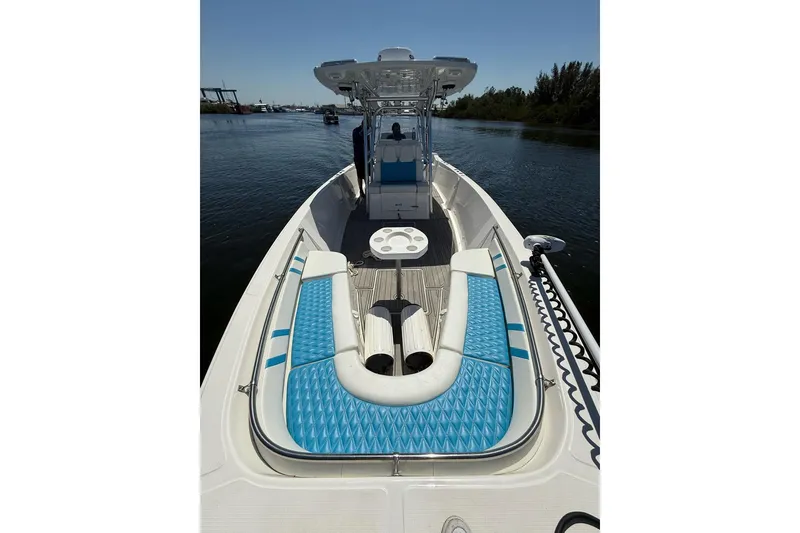 Slide: The Image of 2021 Custom Infusion 34 CC boat with blue seating on calm water. - 11
