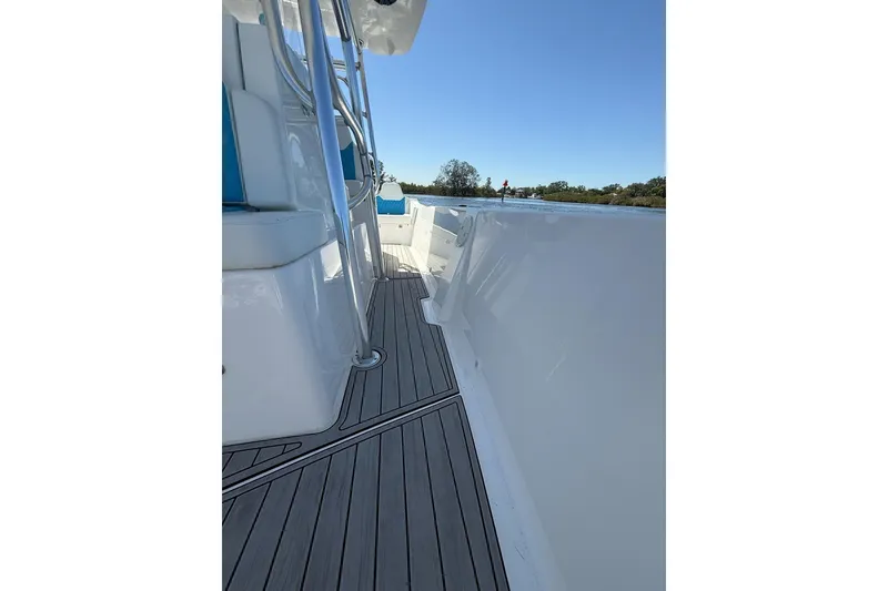 Slide: The Image of 2021 Custom Infusion 34 CC boat deck with sleek design and blue seating. - 18