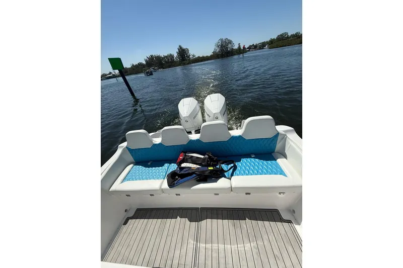 Slide: The Image of 2021 Custom Infusion 34 CC boat with twin engines on a sunny day. - 20