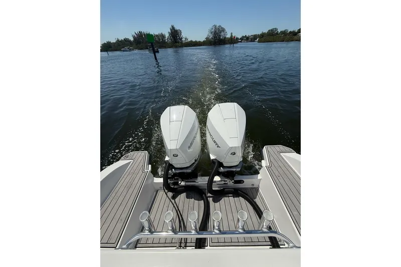 Slide: The Image of Custom Infusion 34 CC 2021 boat with dual Mercury outboard engines on water. - 22