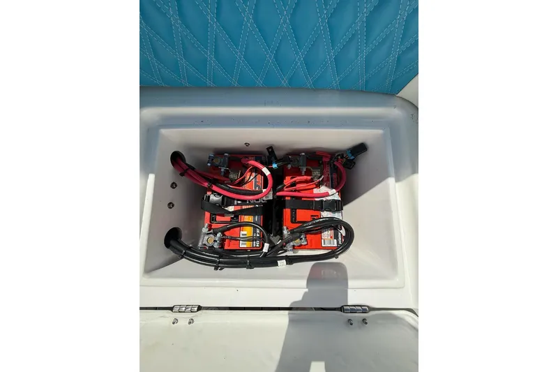 Slide: The Image of Battery compartment of 2021 Custom Infusion 34 CC boat with red and black cables. - 26