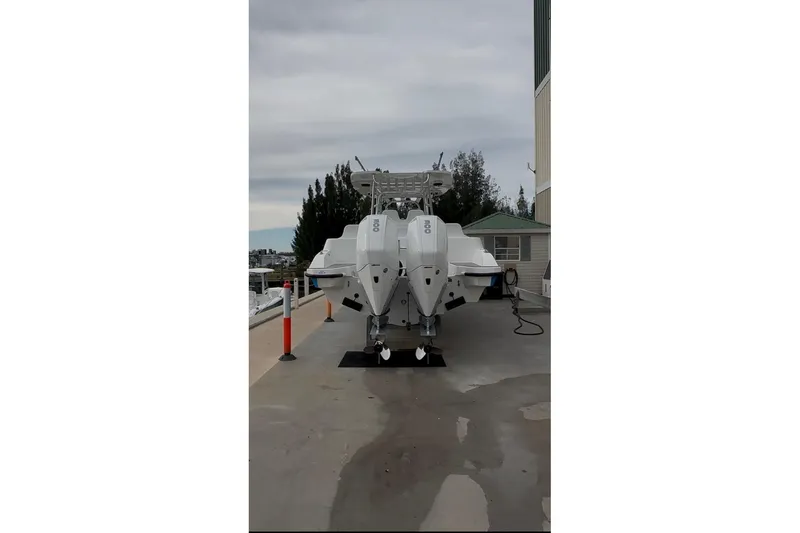 Slide: The Image of 2021 Custom Infusion 34 CC boat with twin engines on a dock. - 3