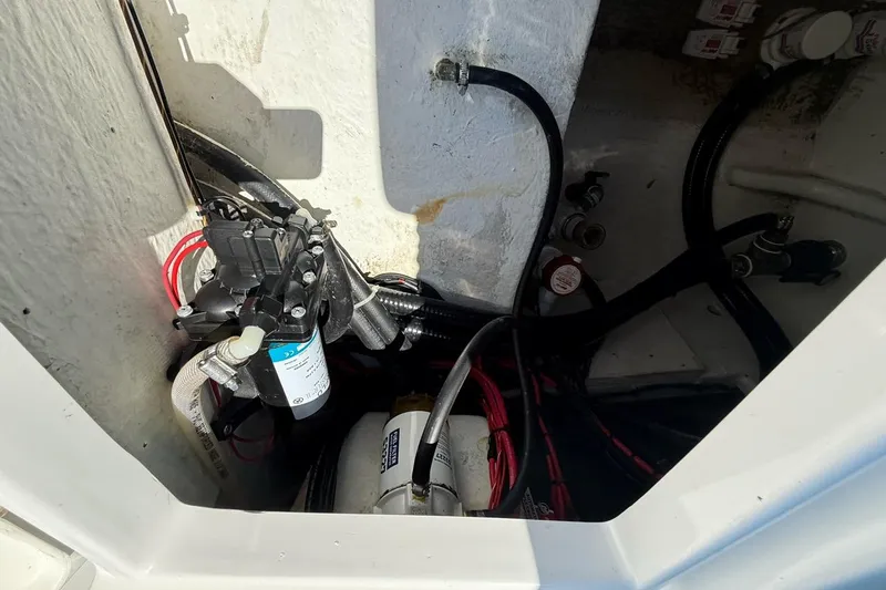 Slide: The Image of Electrical and plumbing components inside a 2021 Custom Infusion 34 CC boat. - 30