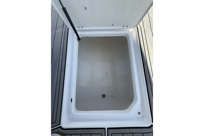 Slide: The Image of Open storage compartment on 2021 Custom Infusion 34 CC boat deck. - 35