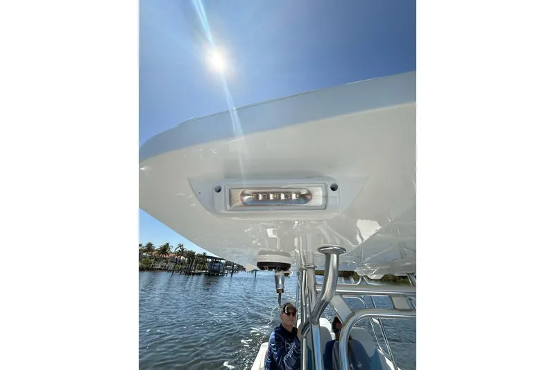 Slide: The Image of 2021 Custom Infusion 34 CC boat under sunny sky, featuring sleek design and modern lighting. - 41