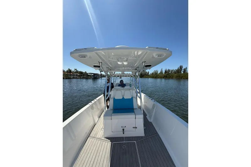 Slide: The Image of 2021 Custom Infusion 34 CC boat on calm water under clear blue sky. - 42