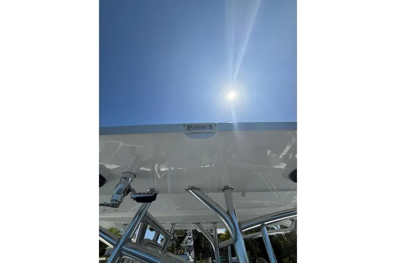 Slide: The Image of Custom Infusion 34 CC boat, 2021 model, viewed from below under a bright sunlit sky. - 43