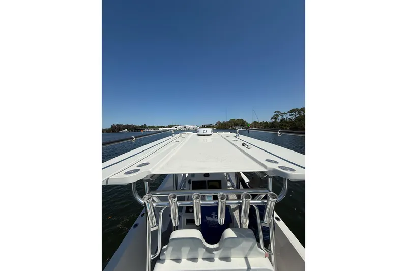 Slide: The Image of 2021 Custom Infusion 34 CC boat on calm water under clear blue sky. - 44
