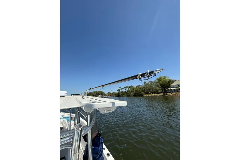 Slide: The Image of Custom Infusion 34 CC boat on a sunny day, 2021 model, near a calm riverbank. - 46