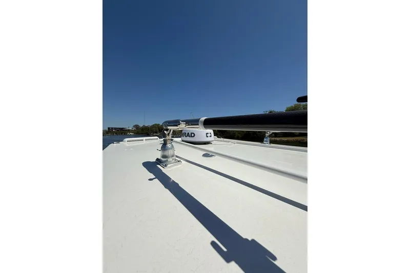 Slide: The Image of 2021 Custom Infusion 34 CC boat deck with radar equipment under clear blue sky. - 47