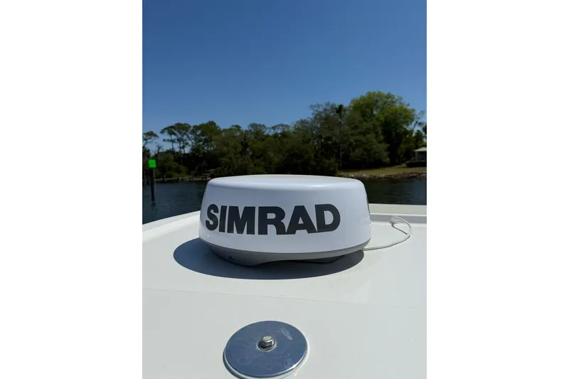 Slide: The Image of Simrad radar on 2021 Custom Infusion 34 CC boat, with scenic waterway background. - 49