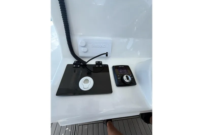 Slide: The Image of Control panel of 2021 Custom Infusion 34 CC boat with Simrad electronics. - 51