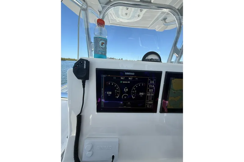 Slide: The Image of Center console of 2021 Custom Infusion 34 CC boat with Simrad display and Gatorade bottle. - 52