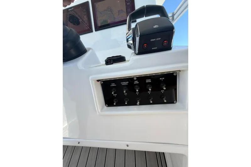 Slide: The Image of Control panel of 2021 Custom Infusion 34 CC boat with switches and navigation screens. - 59