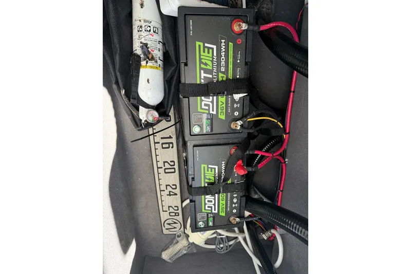 Slide: The Image of Three lithium batteries and a fire extinguisher in a Custom Infusion 34 CC boat, 2021 model. - 61