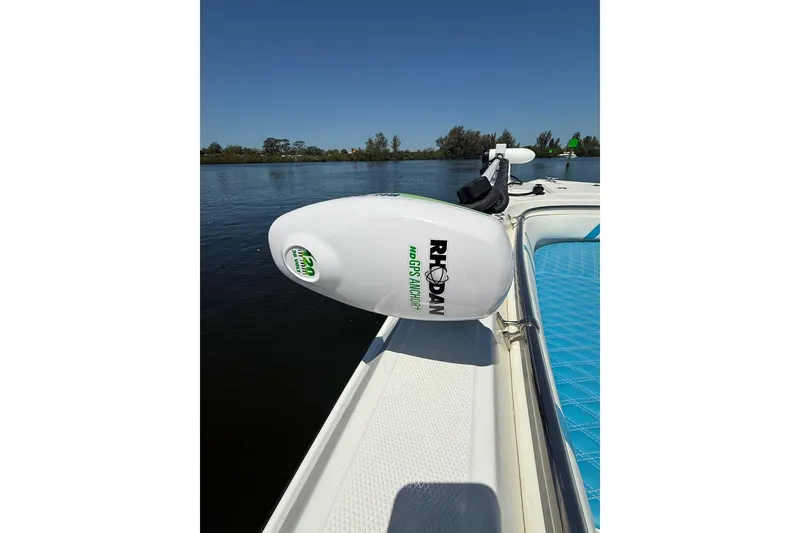 Slide: The Image of Custom Infusion 34 CC 2021 boat with Rhodan GPS anchor, blue seating, on calm water. - 7