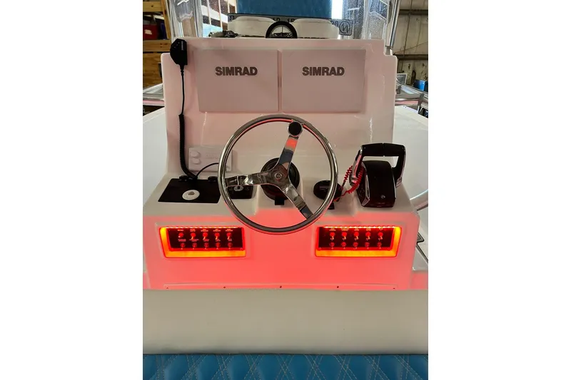 Slide: The Image of Center console of 2021 Custom Infusion 34 CC boat with Simrad electronics and illuminated controls. - 73