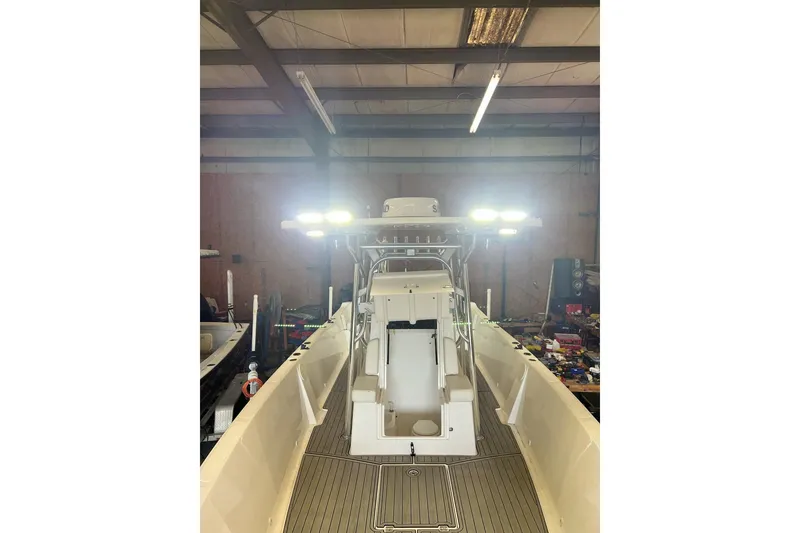 Slide: The Image of 2021 Custom Infusion 34 CC boat in a workshop with bright overhead lights. - 75