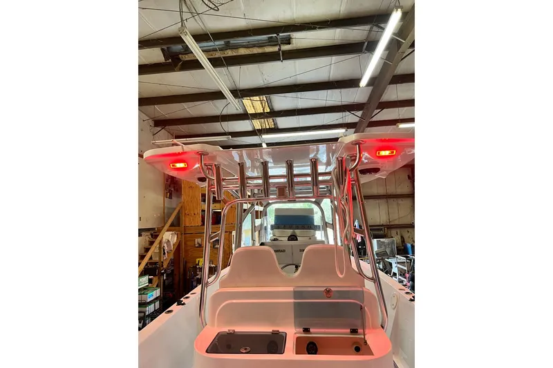Slide: The Image of 2021 Custom Infusion 34 CC boat interior with red lights in a workshop setting. - 78