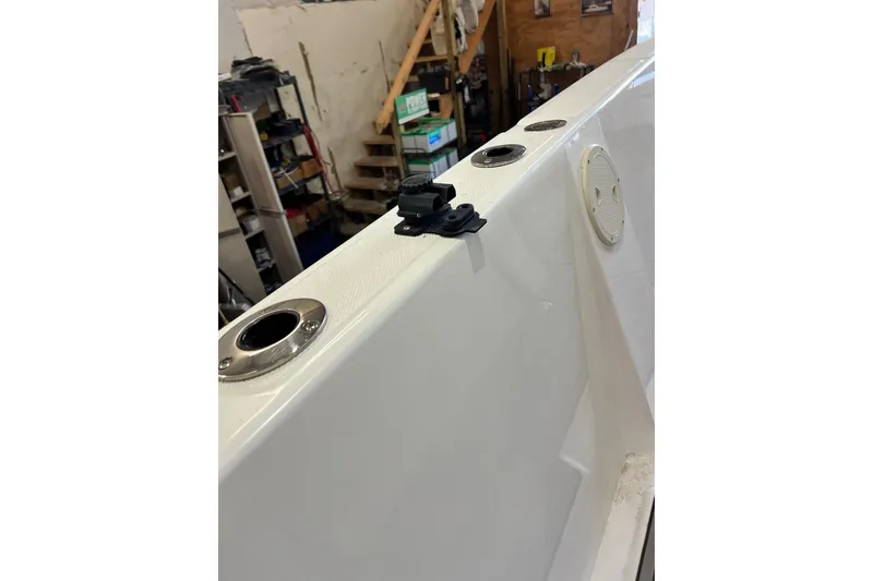 Slide: The Image of 2021 Custom Infusion 34 CC boat deck with rod holders in a workshop. - 79