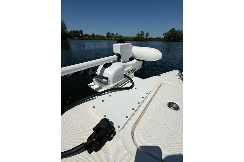 Slide: The Image of 2021 Custom Infusion 34 CC boat with mounted trolling motor on calm water. - 8