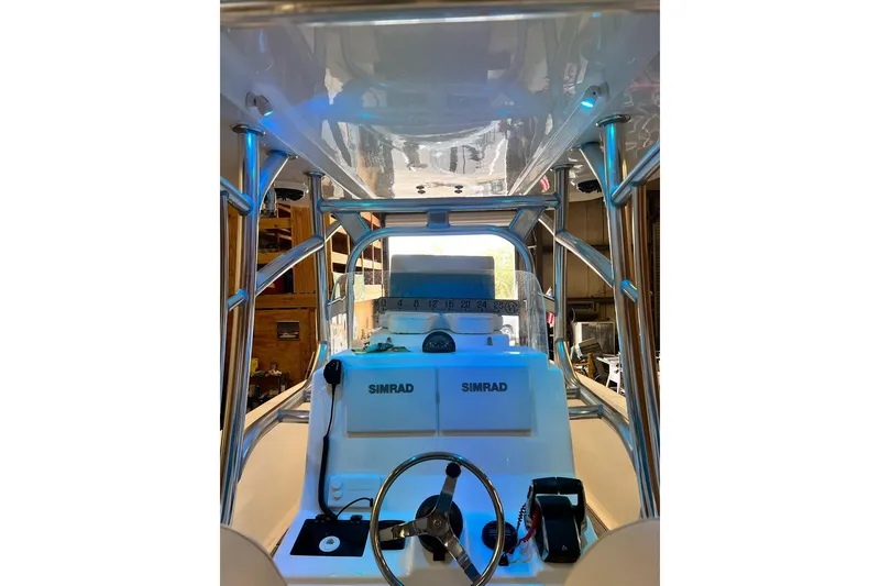 Slide: The Image of 2021 Custom Infusion 34 CC boat dashboard with Simrad electronics and steering wheel. - 83