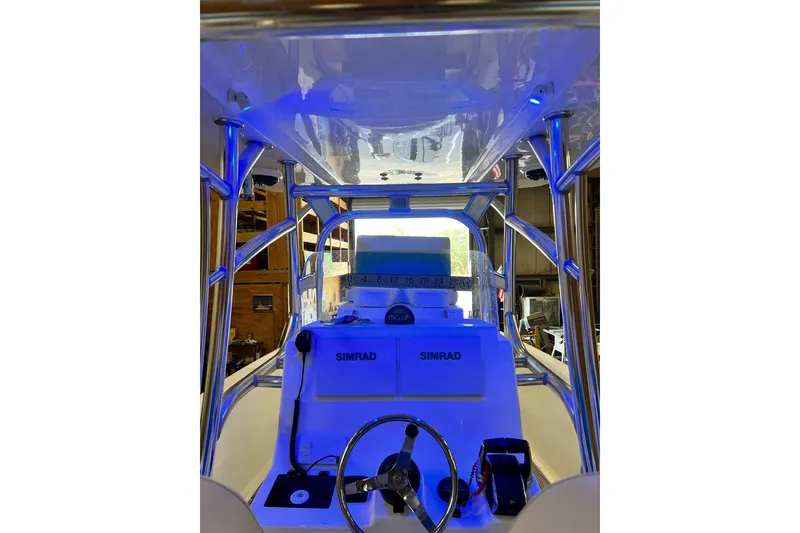 Slide: The Image of 2021 Custom Infusion 34 CC boat interior with Simrad electronics and blue lighting. - 84