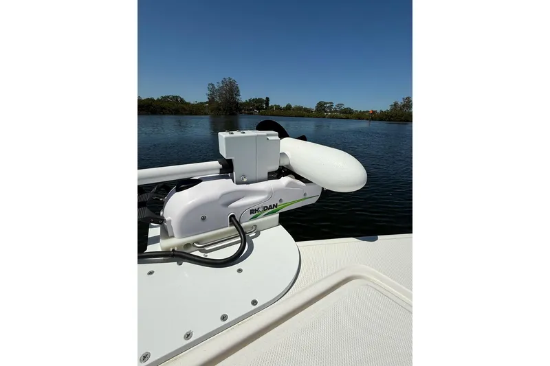Slide: The Image of Custom Infusion 34 CC boat, 2021 model, with trolling motor on calm water. - 9