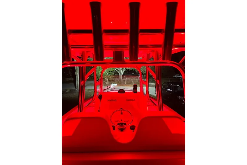 Slide: The Image of Red-lit interior of a 2021 Custom Infusion 34 CC boat at night. - 92