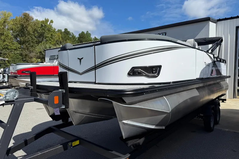 The Image of 2026 Tahoe Pontoon LTZ Versatile Rear Lounger on trailer, outdoor display. - 0