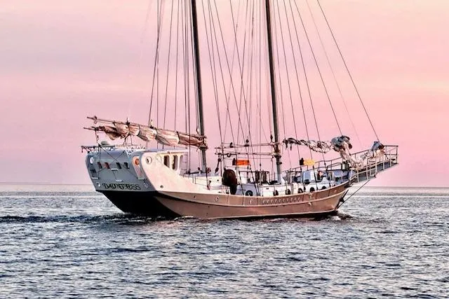 The Image of Custom 1989 Schooner Live aboard sailing at sunset on calm waters. - 1
