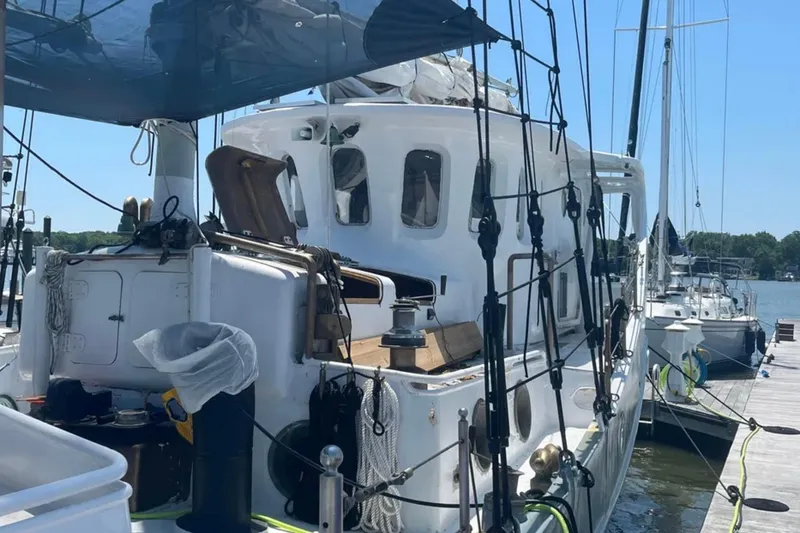 Slide: The Image of 1989 Custom Schooner Live aboard docked at marina under clear blue sky. - 7