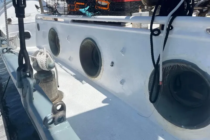 Slide: The Image of 1989 Custom Schooner Liveaboard deck with portholes and ropes, docked at marina. - 8