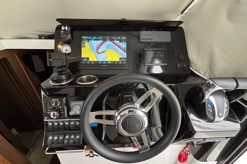 Slide: The Image of 2022 Jeanneau NC Weekender 1095 Fly boat docked, showcasing sleek deck design. - 10