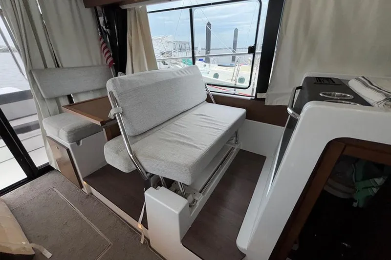 Slide: The Image of Interior of 2022 Jeanneau NC Weekender 1095 Fly, featuring modern kitchen and seating area. - 18